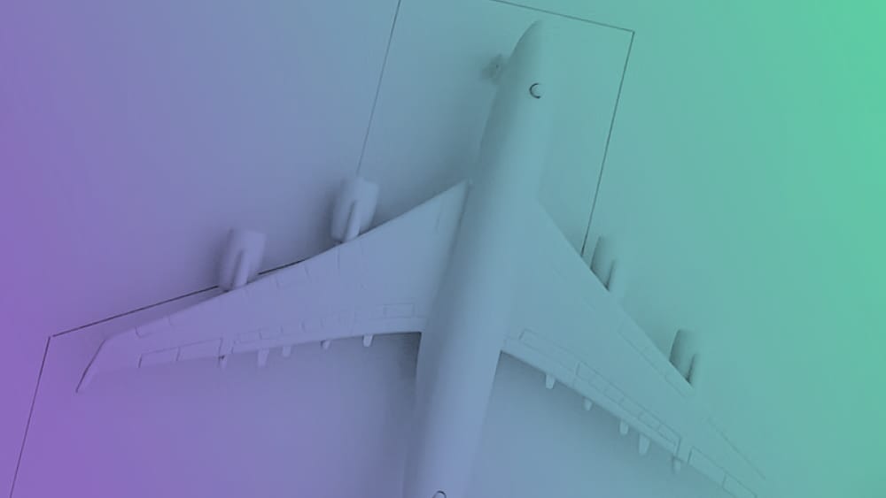 Overhead view of a white plane model, symbolizing global reach.