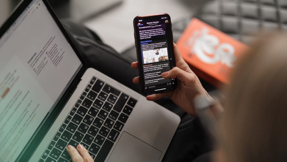 Image of a woman looking at a laptop, learning about brand awareness.