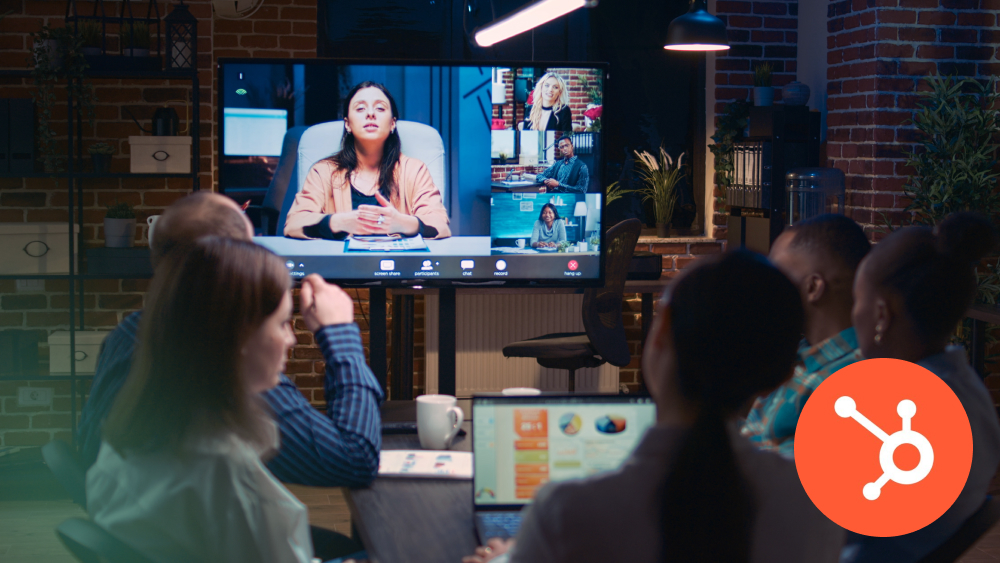 Team having a virtual meeting with HubSpot logo in foreground
